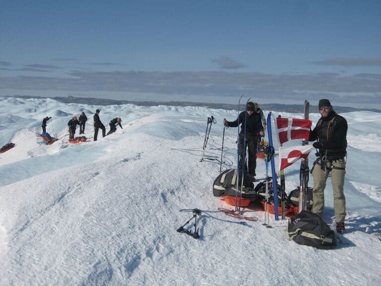 Krydsning af Grønlands Indlandsis 2013, dit eventyr, ekspeditionsleder Erik B. Jørgensen, deltager Kenneth Dankleff Lagstrøm, med flag bed bræfaldet. Holdet på vej op på indlandsisen